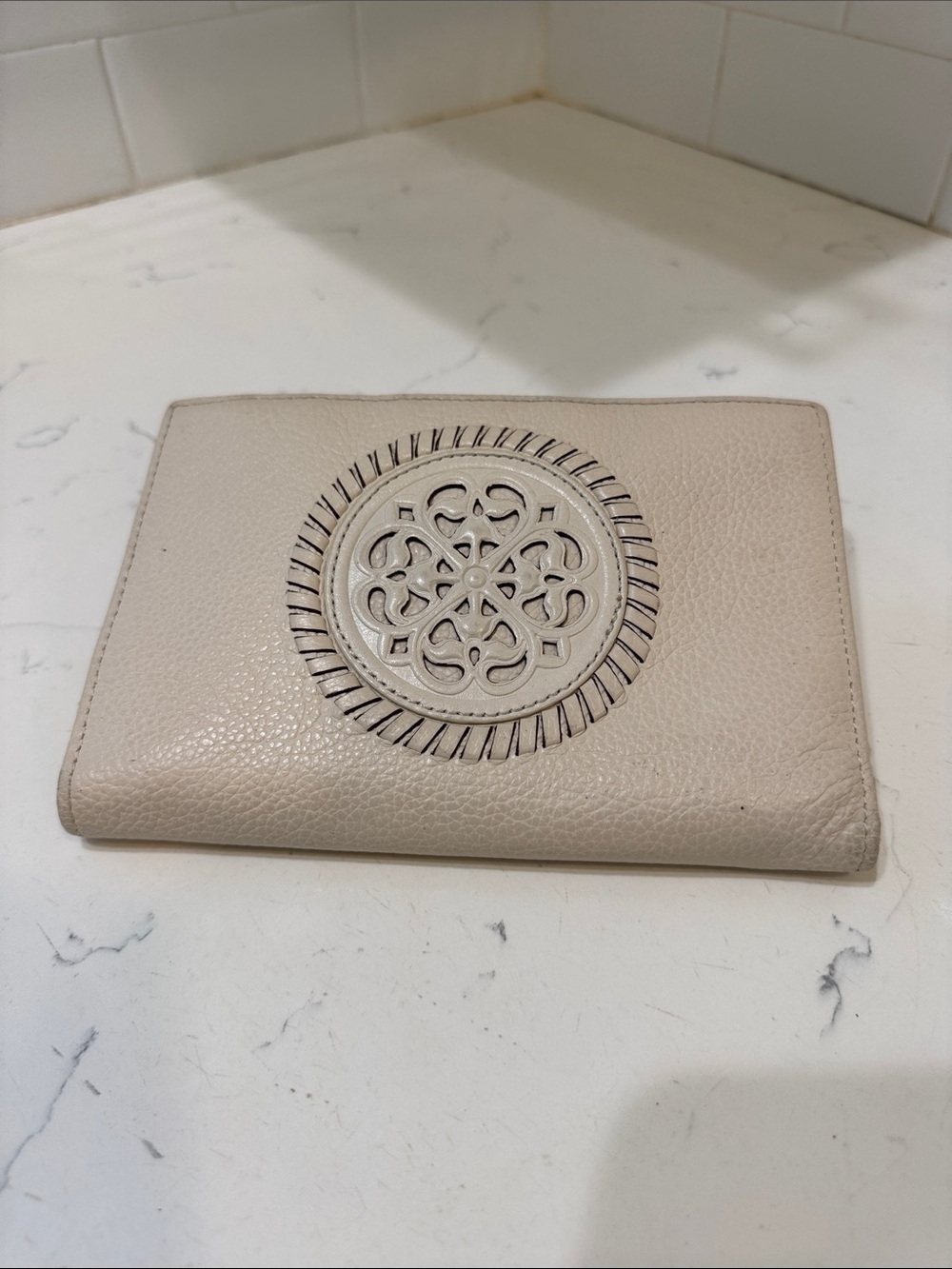 Brighton Cream Pebbled Leather Ferrara Fold Wallet with Embossed Medallion
